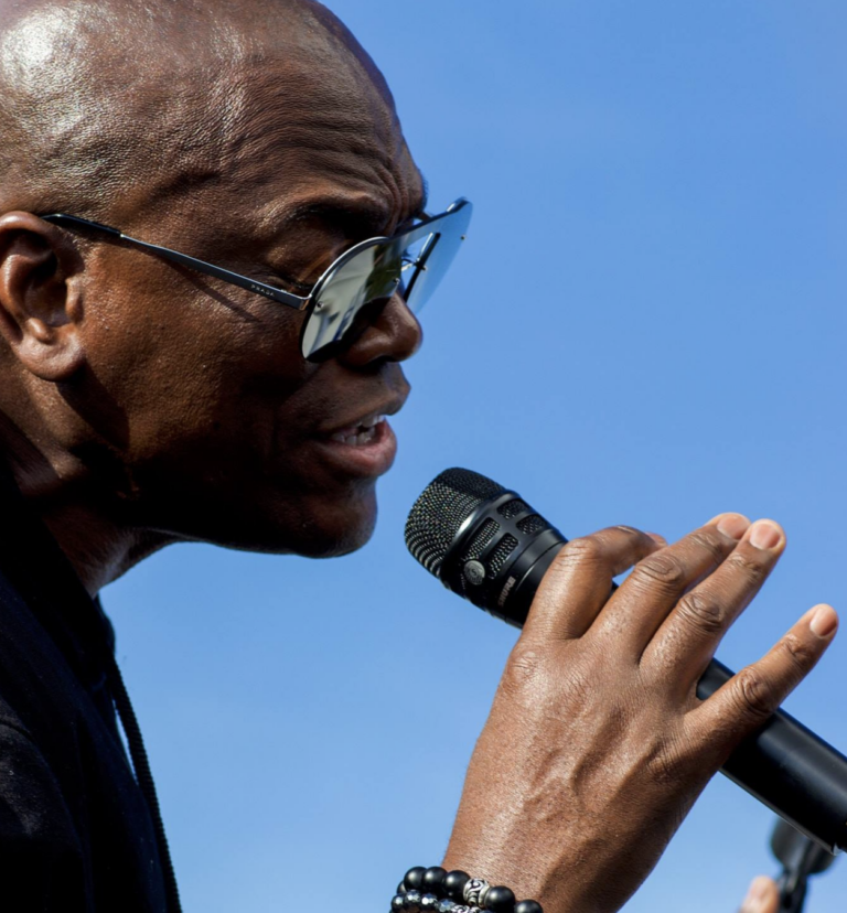 Ray Greene singing with sunglasses on