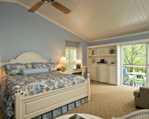 Hotel room with a bed and bookcase garden view.
