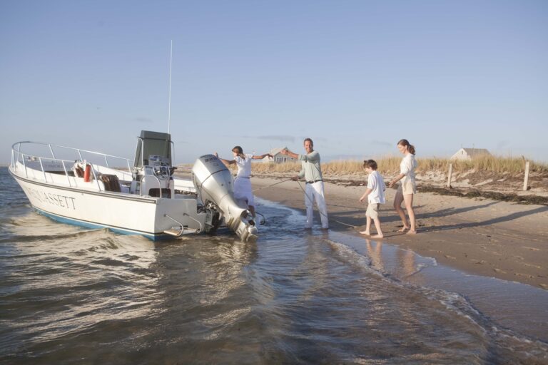 family getting into boat beach