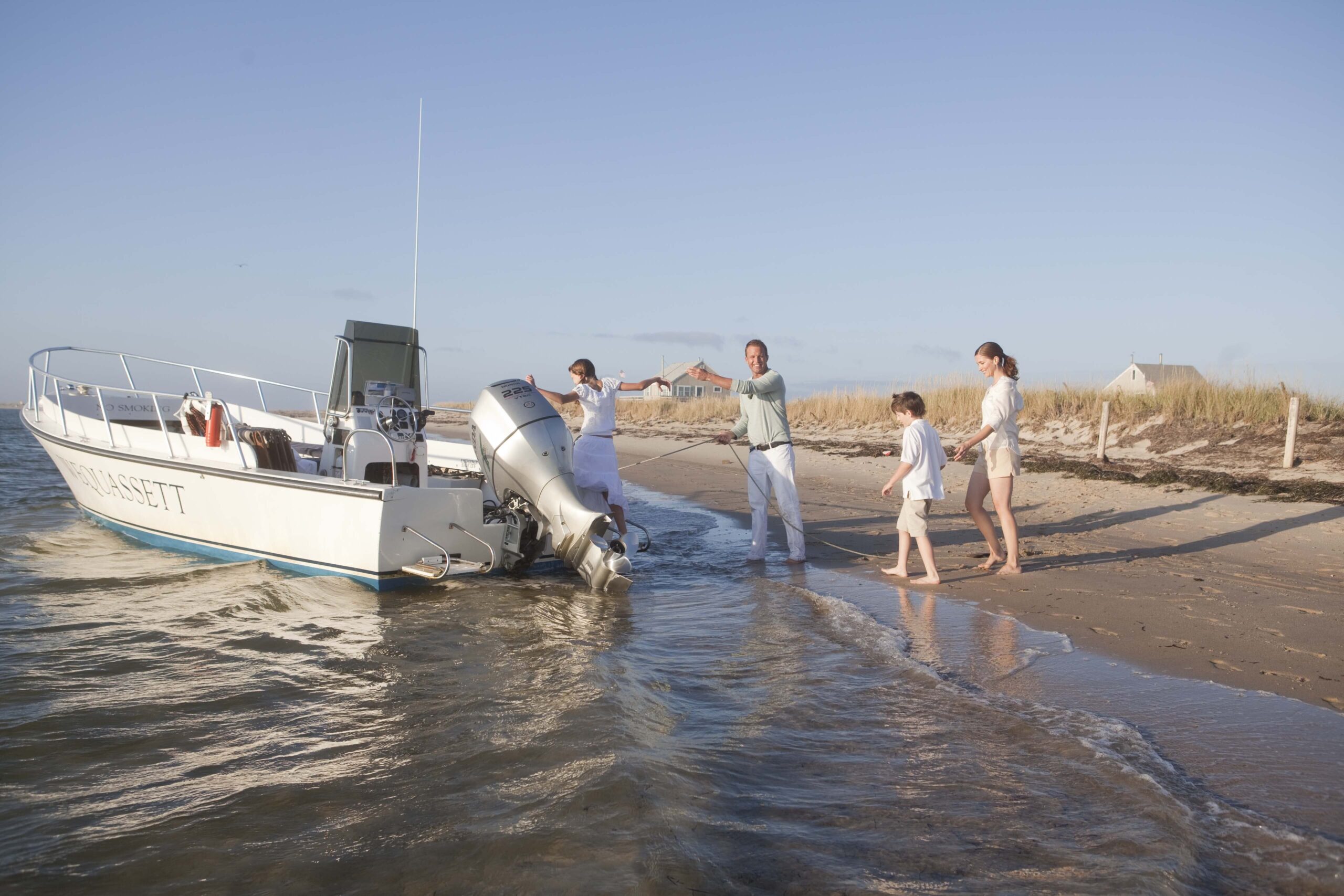 family getting into boat beach