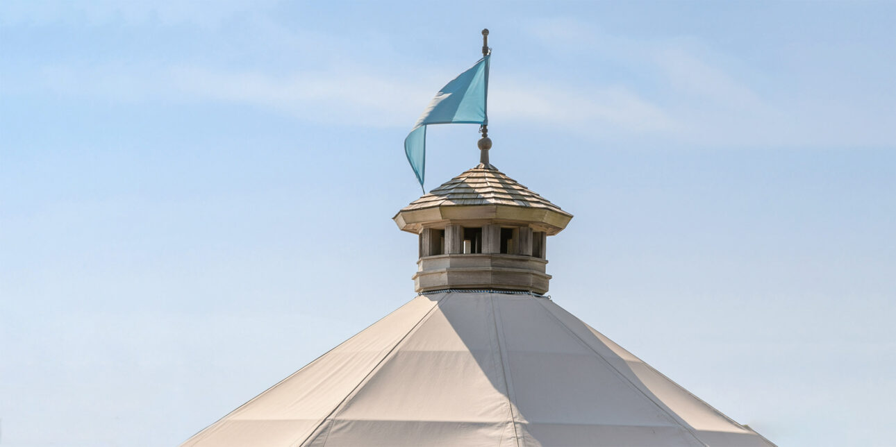Top of gazebo with a blue fag on the top.
