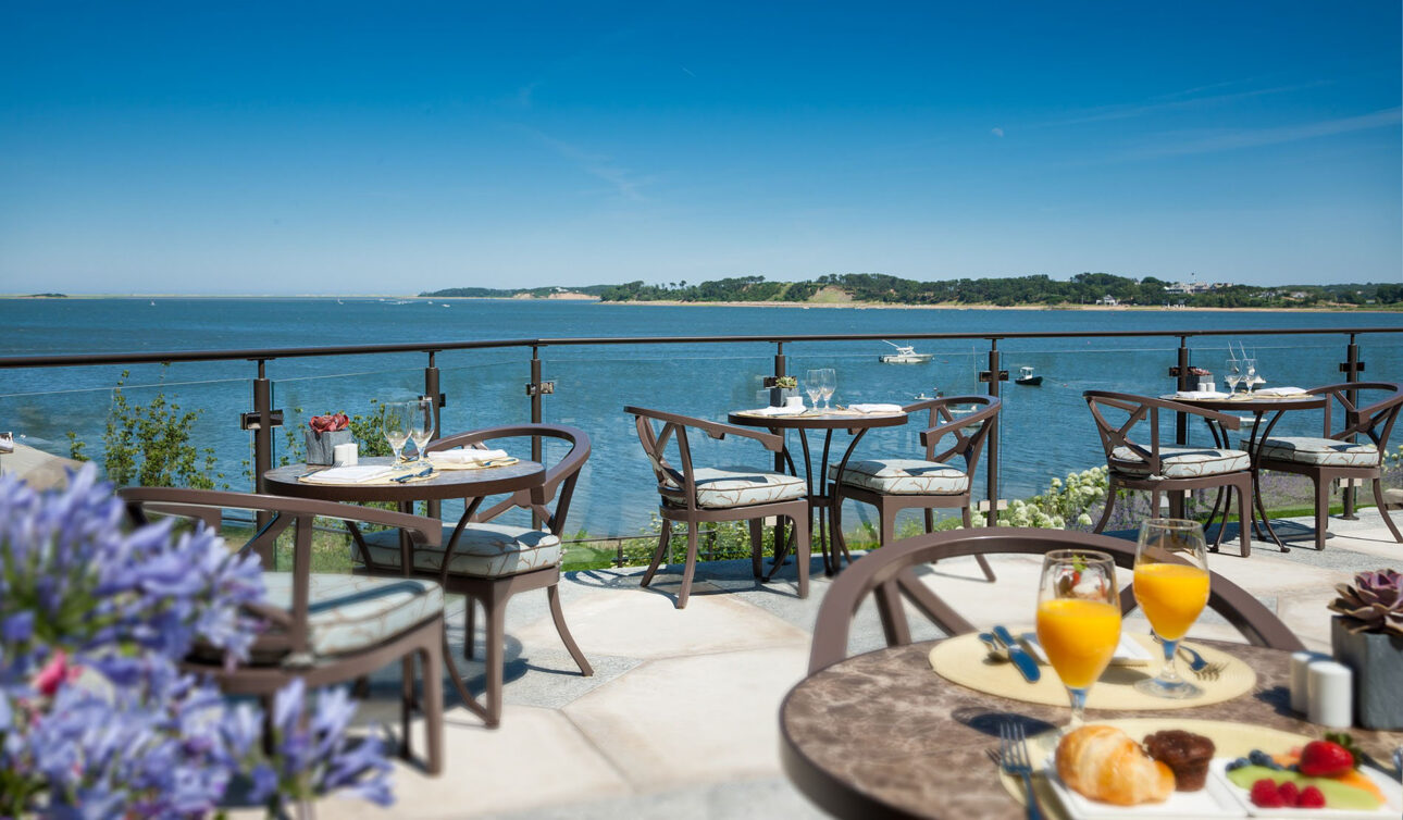 Tables with glasses and ocean view.