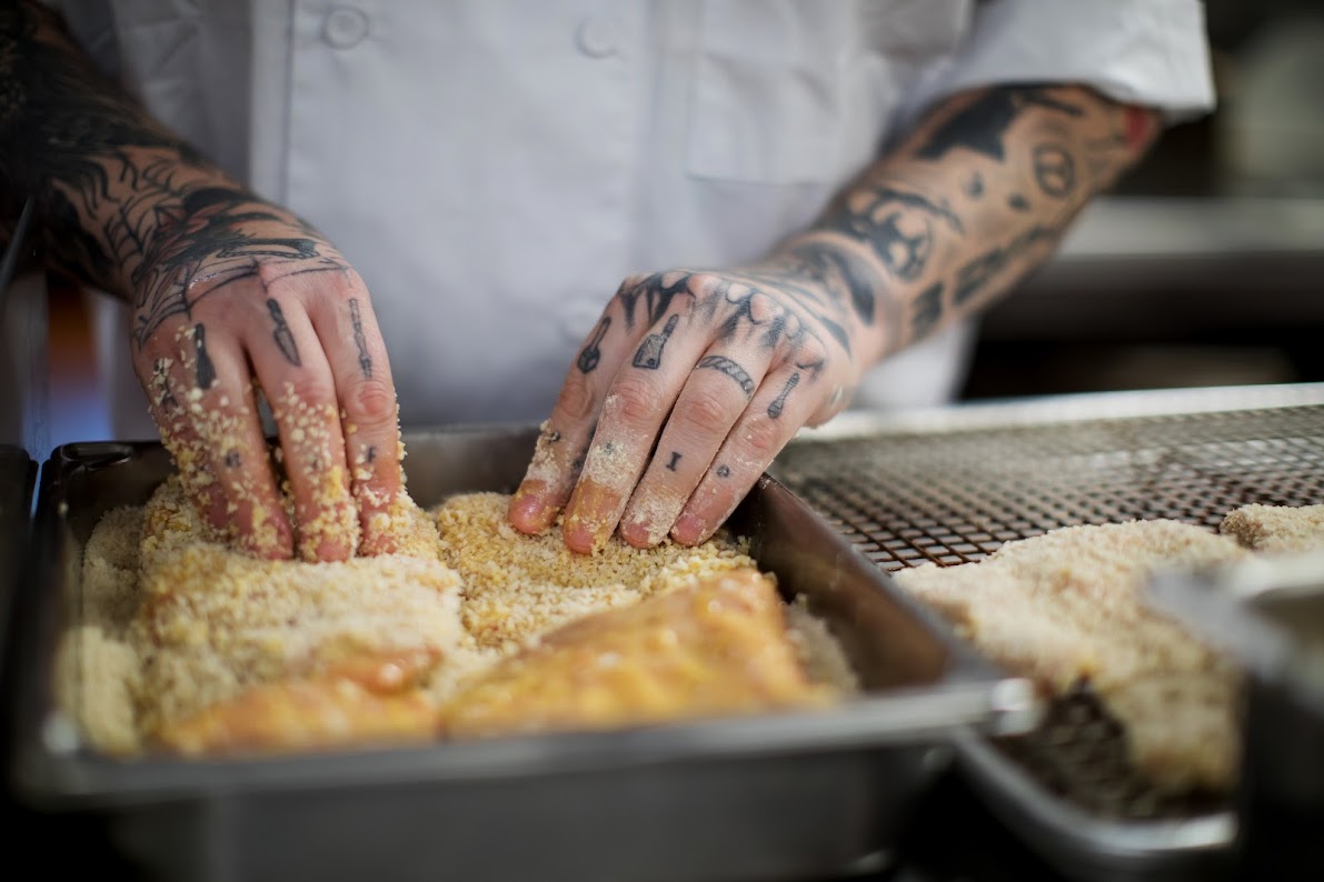 Chef preparing food in a kitchen.